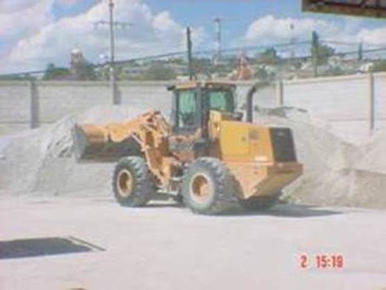 Loader picking up aggregates from storage piles